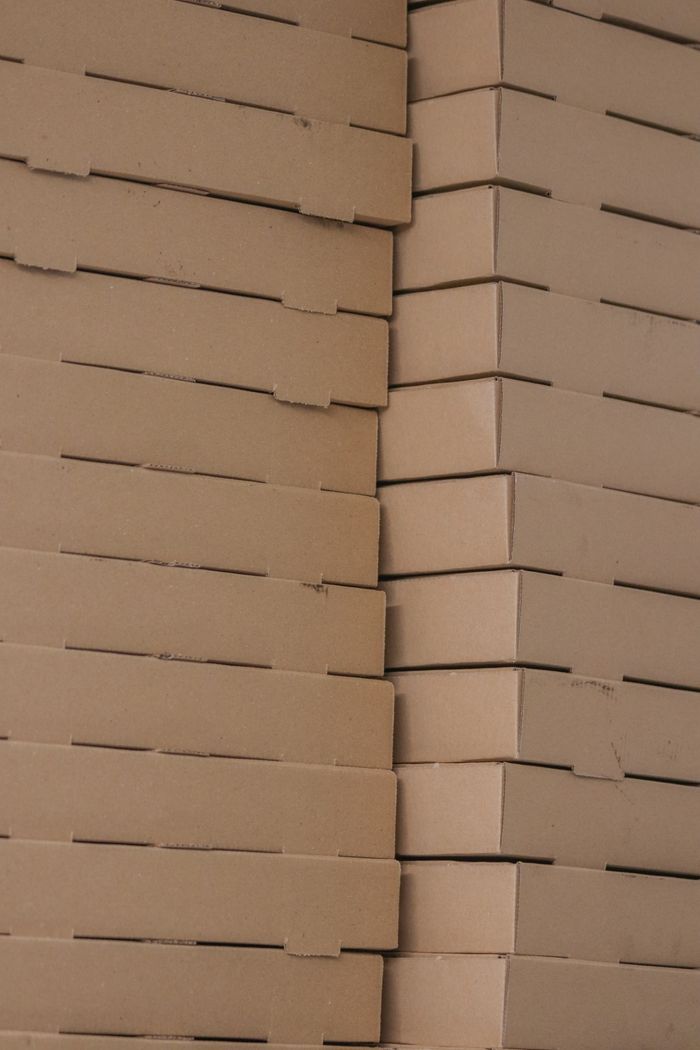 Detail shot of stacked brown cardboard boxes showing texture and symmetry.